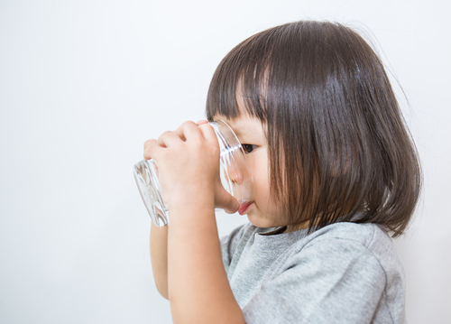 toddler drinking water from a cup